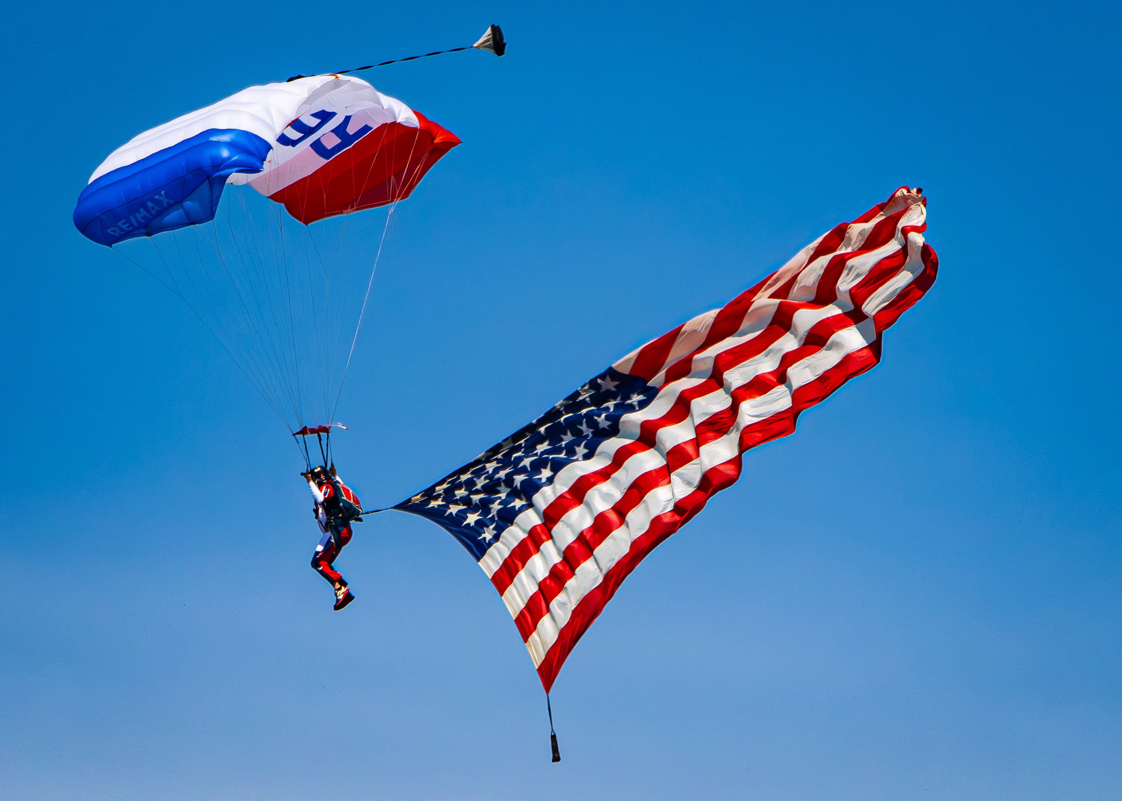 A parachutist with an American flag